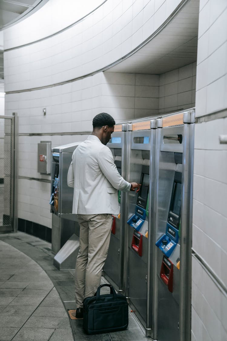 A Man Buying Ticket In The Train Station