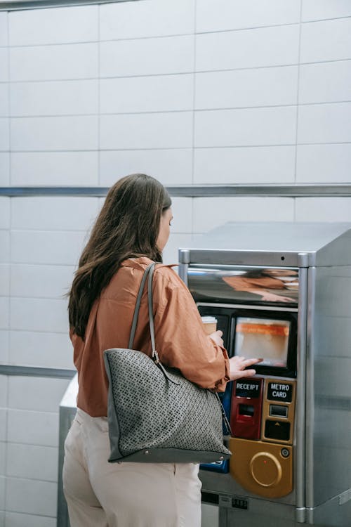 A Woman at a Ticket Vending Machine