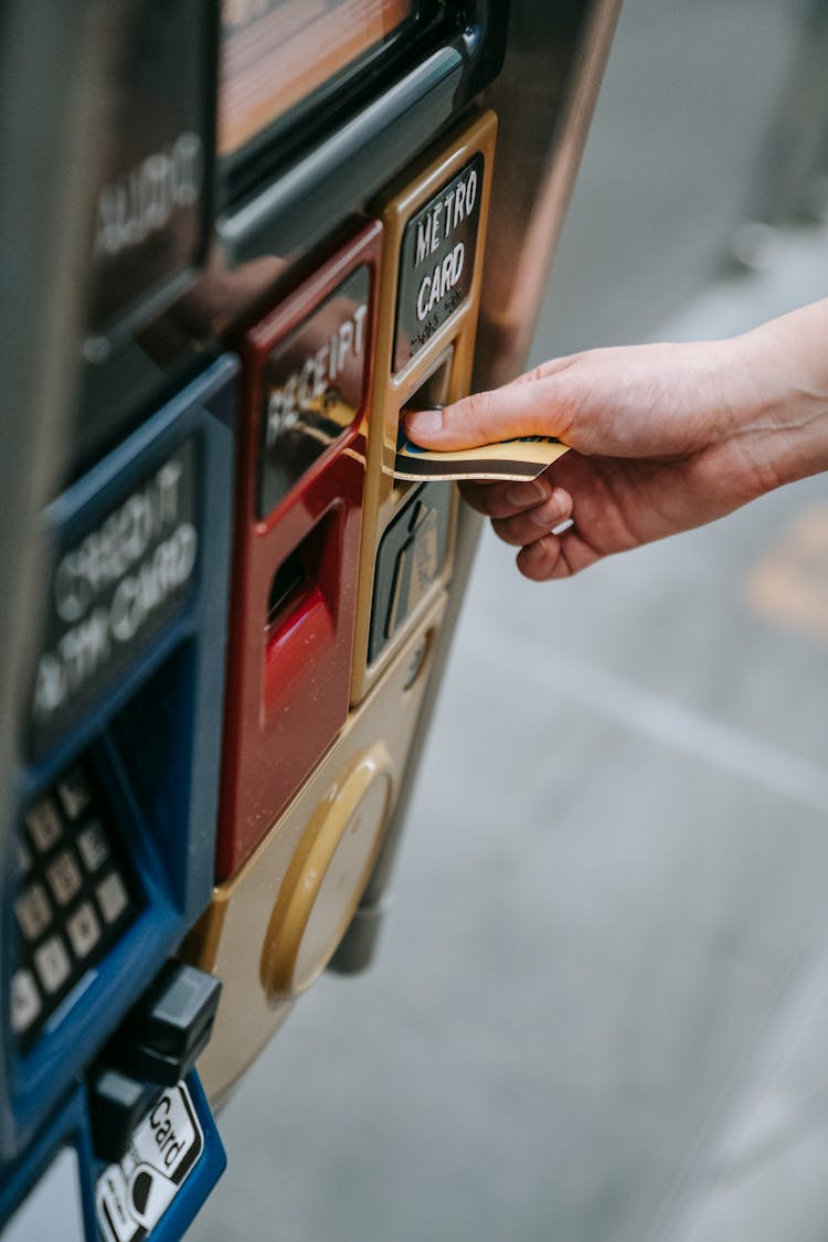 Person Purchasing Ticket From Vending Machine