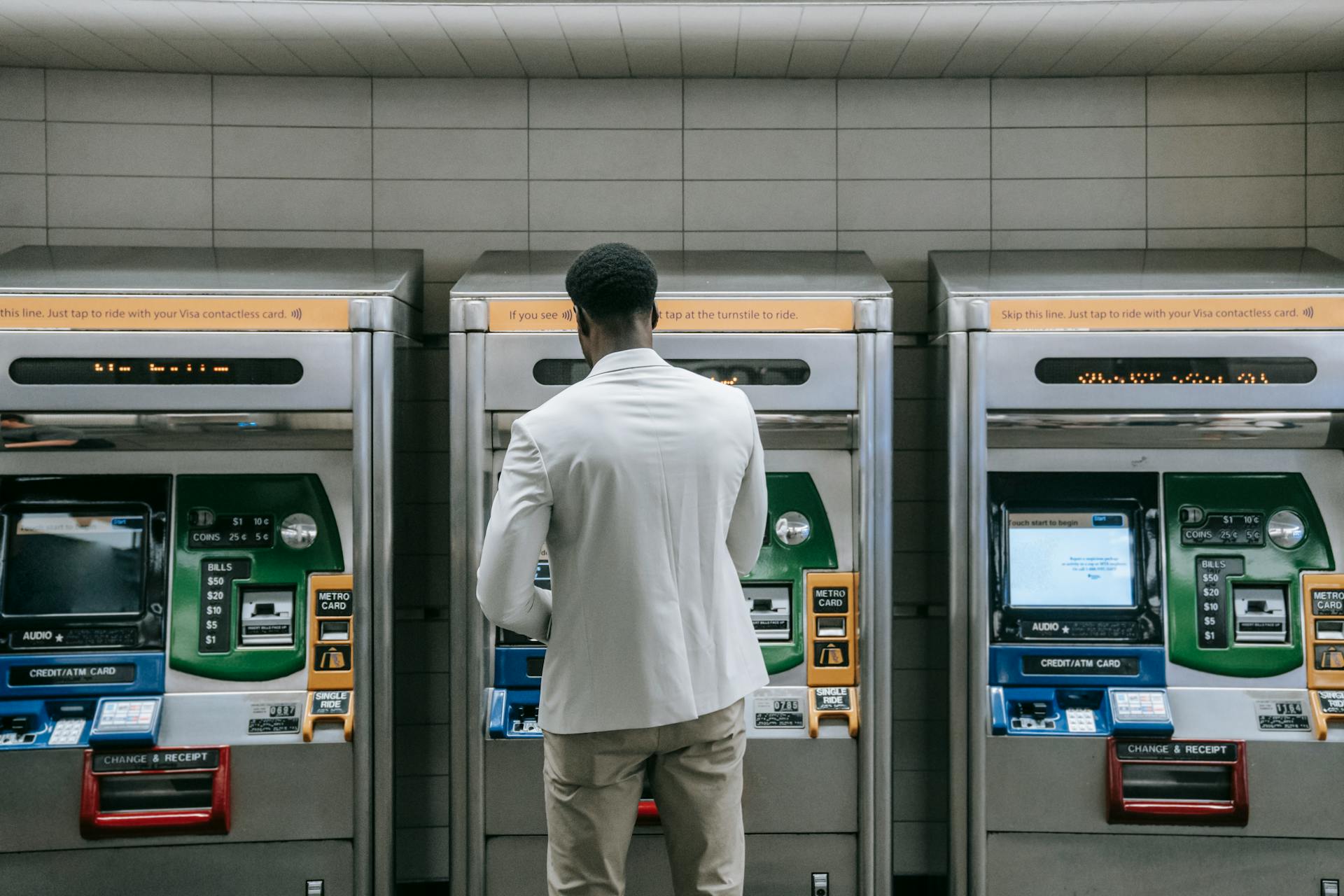 Man Standing in front of a Machine