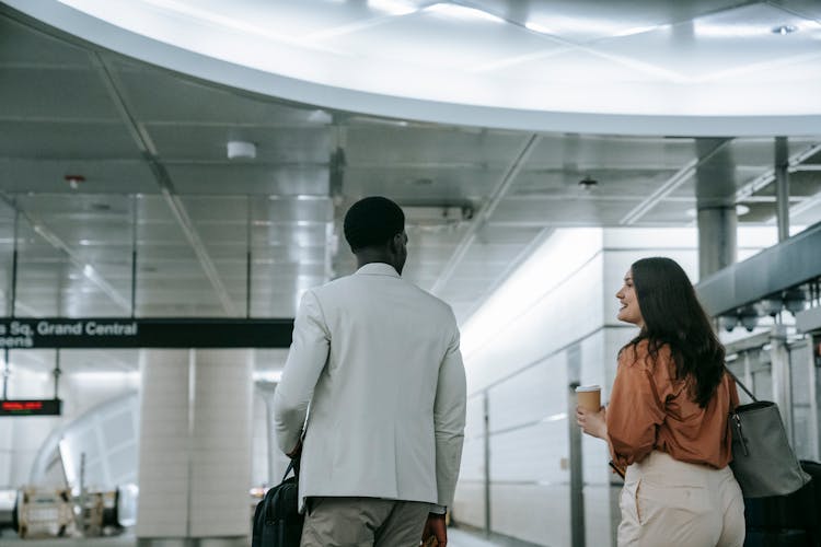 Back View Of A Woman And Man Walking Together 