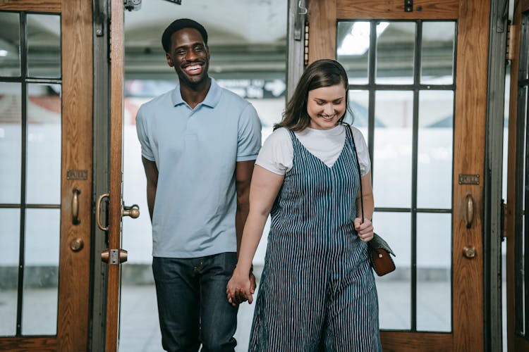 Man And Woman Walking Out Of The Door