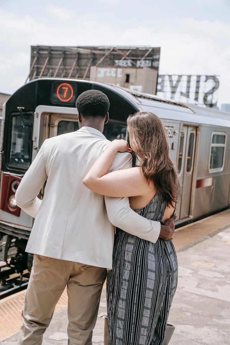 Back View Of A Couple Waiting For The Train