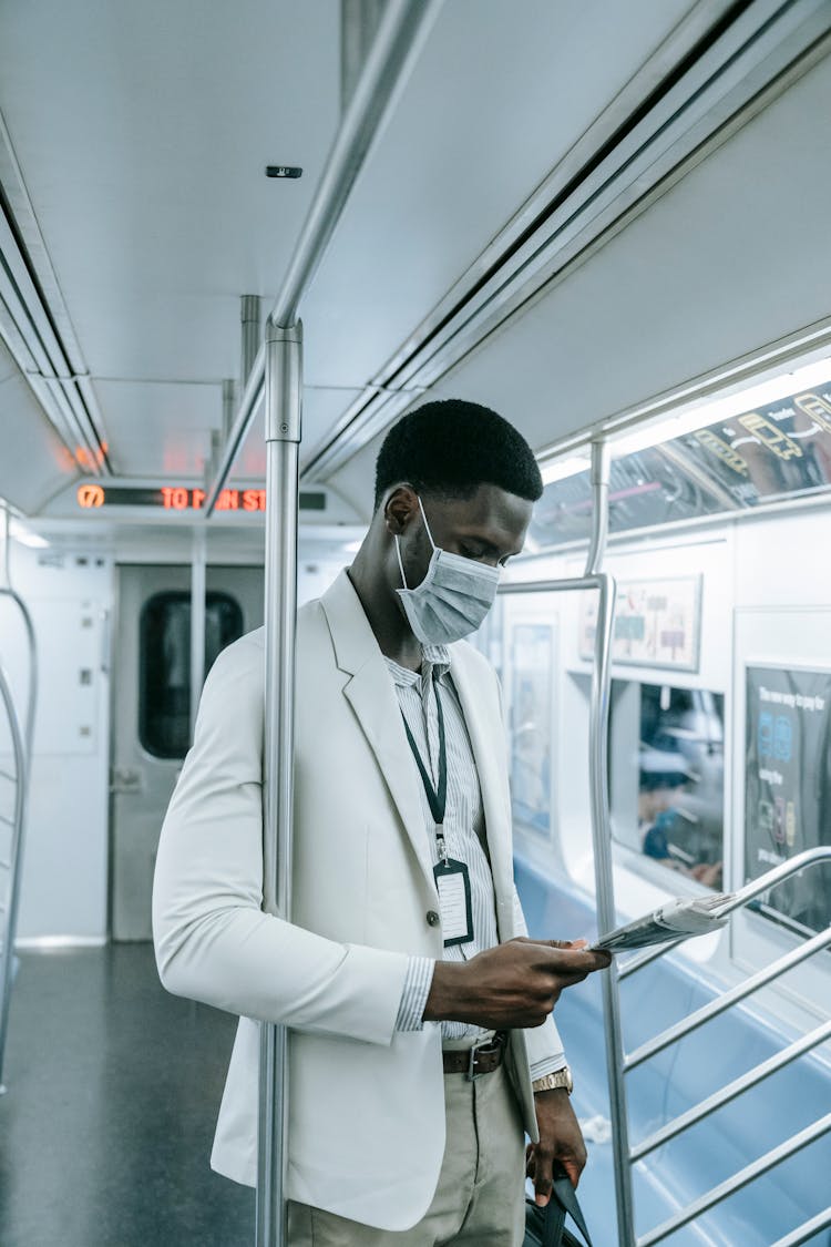 Man Inside A Train Holding Magazine