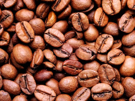 High-quality close-up image of aromatic roasted coffee beans, perfect for food and beverage themes.