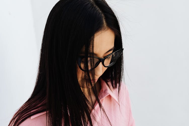 Woman In Pink Shirt Wearing Black Framed Eyeglasses