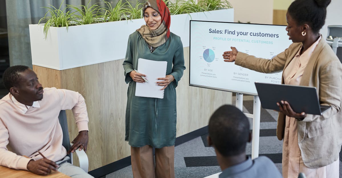 Team of professionals discussing sales strategy during a business presentation in a modern office.