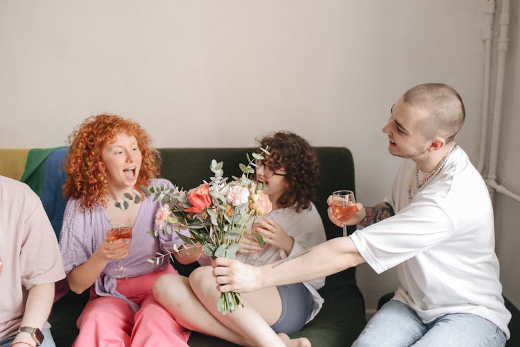 Man Giving A Woman A Bouquet Of Flowers