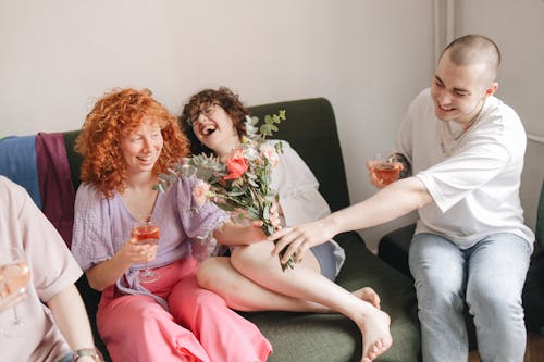 Group of Friends Sitting, Drinking Wine and Laughing 