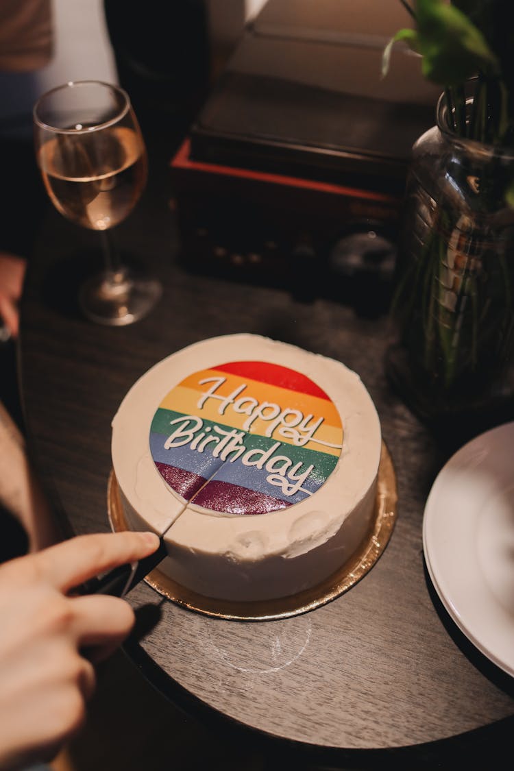 A Person Slicing A Cake