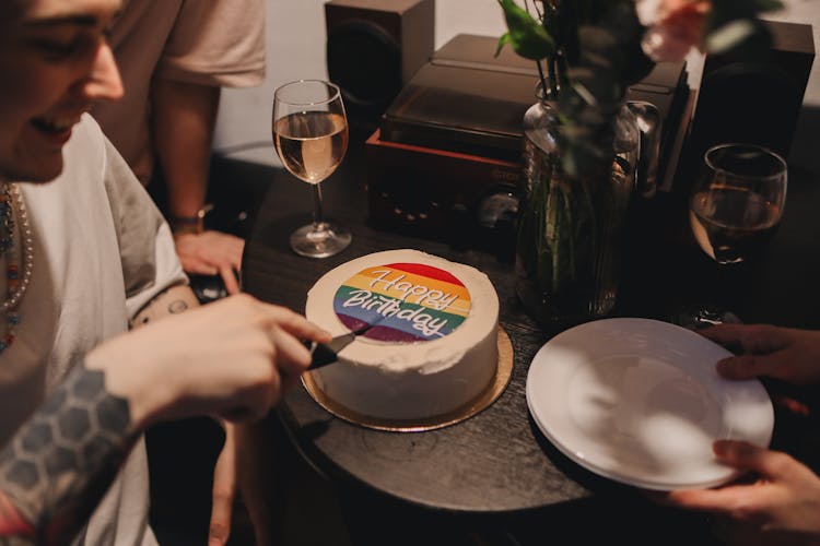 A Person Slicing A Cake