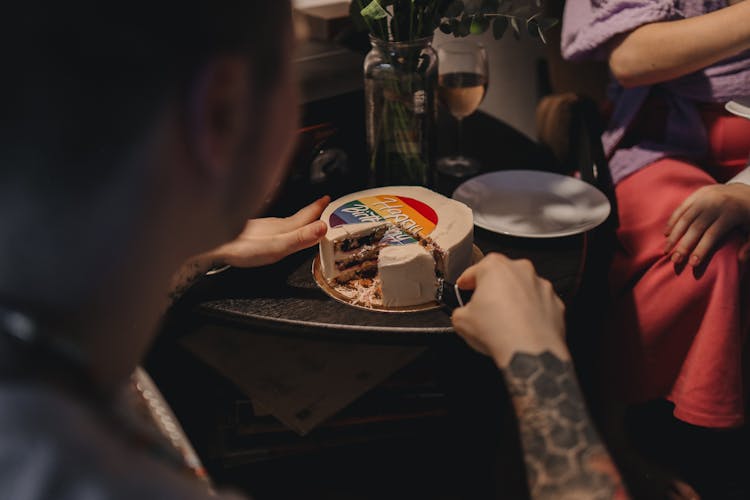 A Person Slicing A Cake