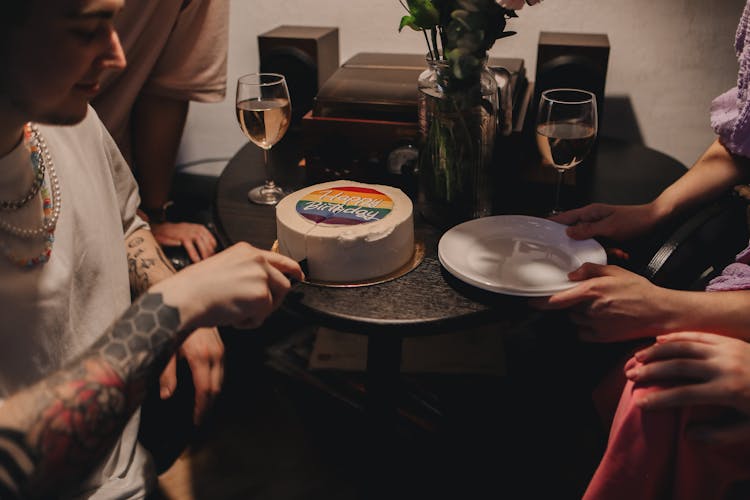 A Person Slicing A Cake