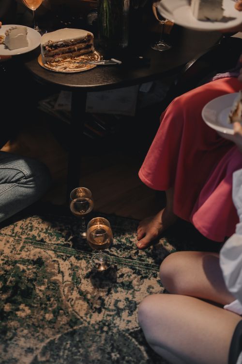 Free An intimate indoor gathering with friends enjoying wine and cake. Stock Photo