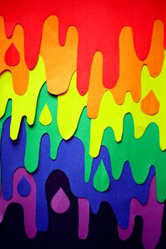 Colorful paper cut artwork featuring rainbow hues and dripping patterns.