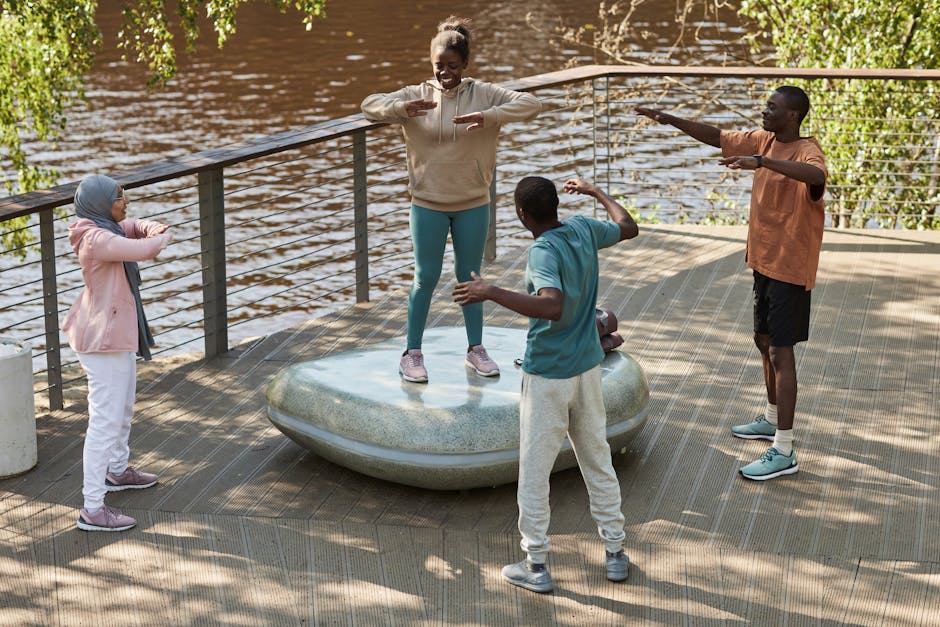 Friends enjoying an outdoor workout on a waterside deck, promoting health and togetherness.