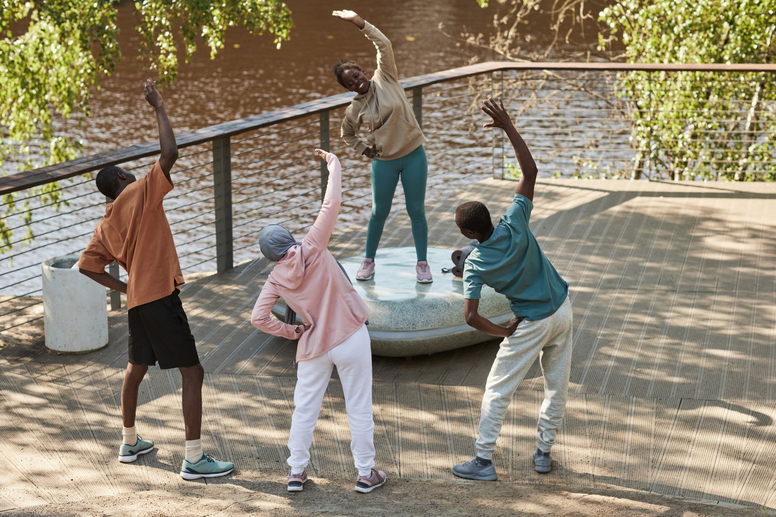 Adults stretching together outdoors