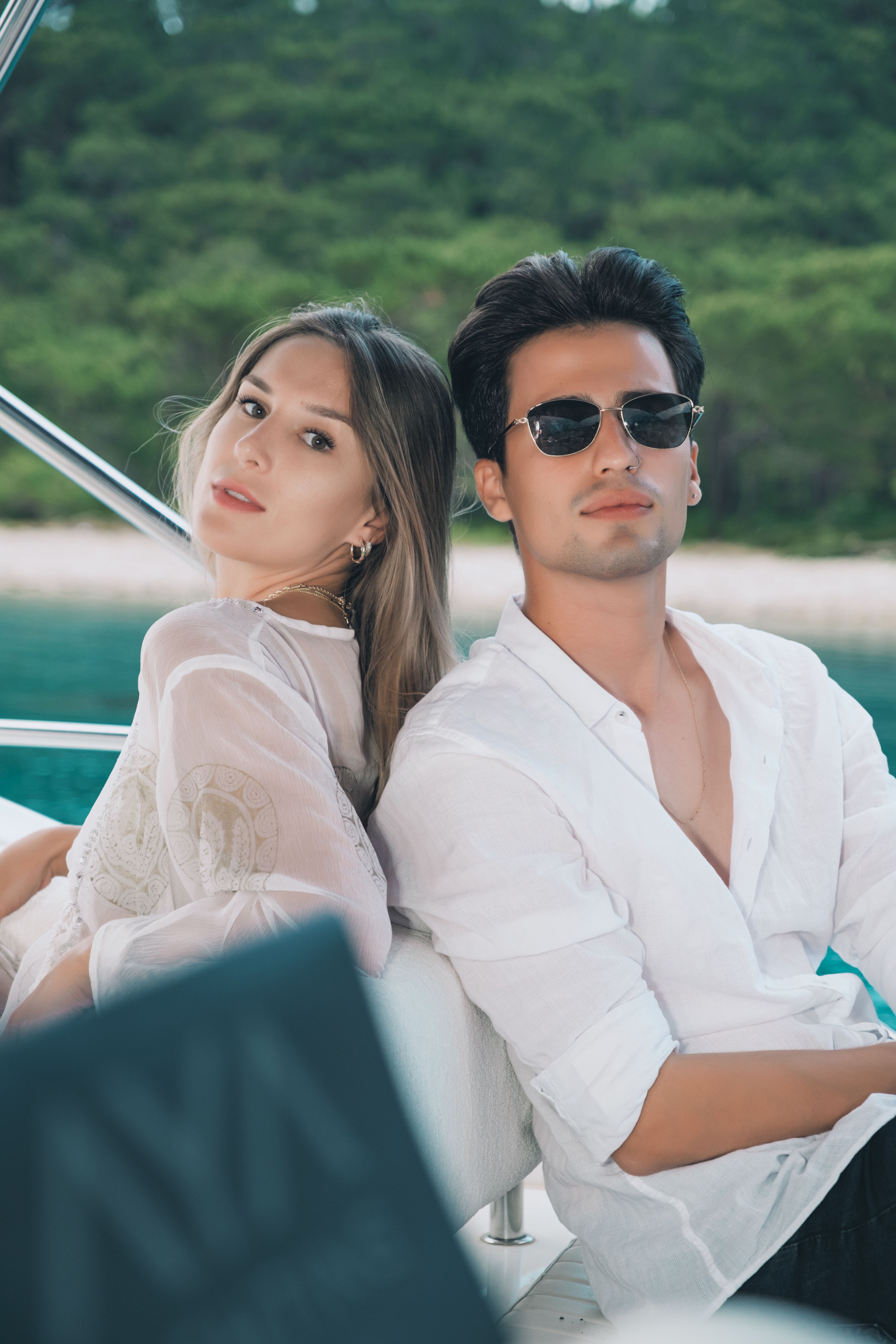 A stylish couple enjoying a leisurely day on a yacht in Antalya, Türkiye.