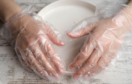 Hands in Plastic Gloves