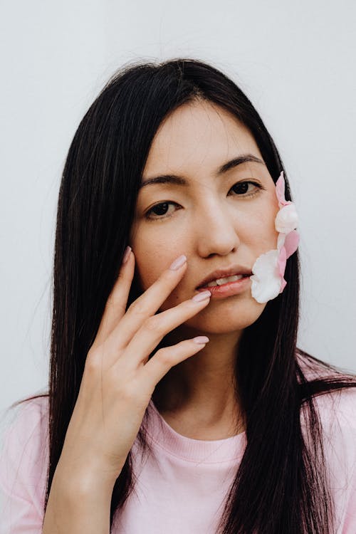 Woman with Petals on Face