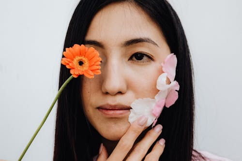 Barberton Daisy Covering a Woman's Eye