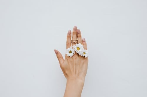 Rings and Flowers on Woman Hand
