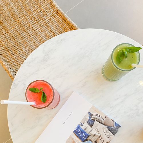 Free Top view of green and red smoothies on a marble table with a magazine, perfect for a healthy lifestyle setting. Stock Photo