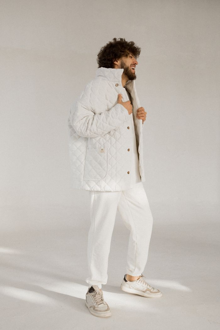 A cream quilted field jacket in a studio — photo by Роман Павлов on Pexels