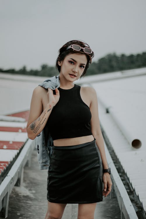 Selective Focus Photo of a Woman in a Black Crop Top Looking at the Camera