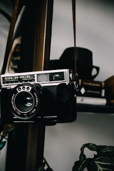 A classic Sokol film camera beautifully displayed on a wooden shelf, evoking nostalgia.