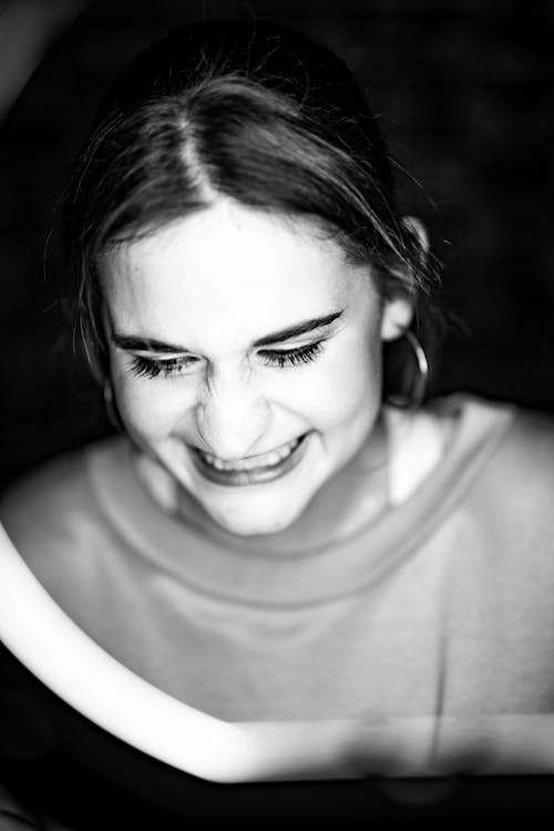 Grayscale Photo of a Girl Smiling