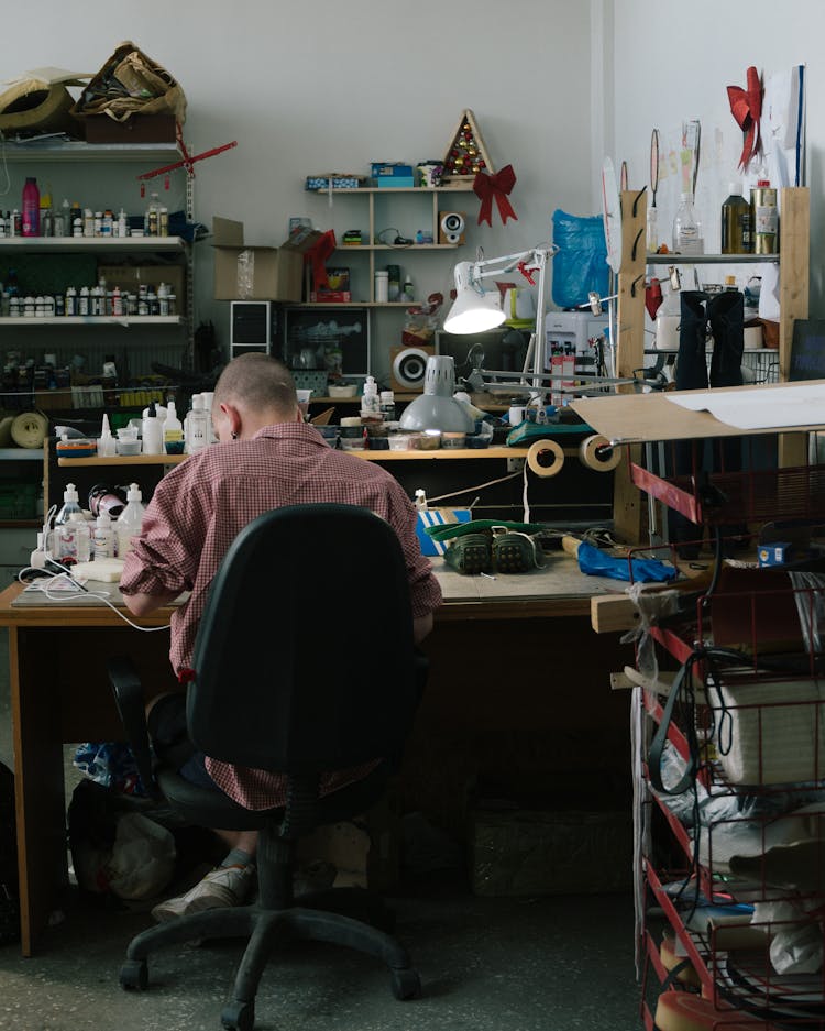 Back View Of A Man Sitting On The Chair 