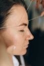 A Side View of a Woman Having a Threading Procedure