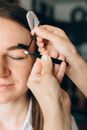 A Person Plucking the Woman's Eyebrow