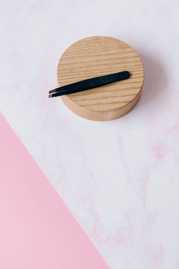 Tweezers On Round Wood 