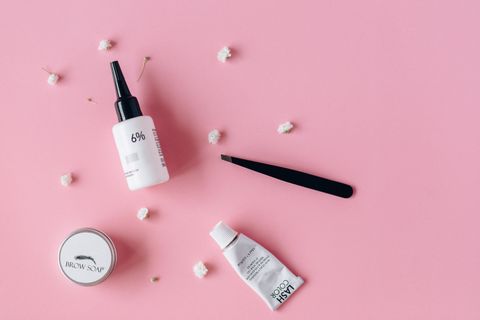 Skincare bottles arranged on a pink surface, photo by Nataliya Vaitkevich on Pexels
