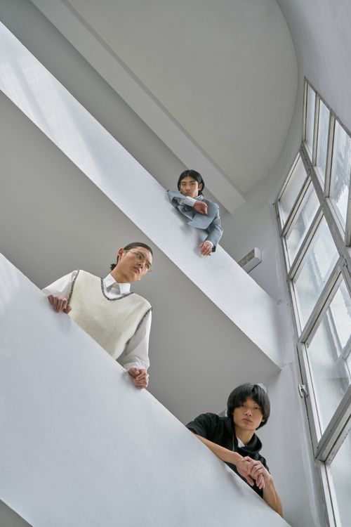 Free Low angle portrait of three adults indoors, capturing minimalist design with natural light. Stock Photo