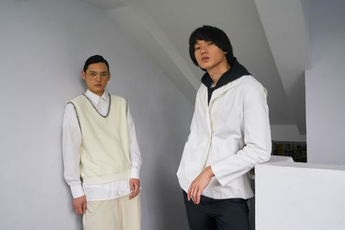 Free Two stylish Asian men posing in modern fashion indoors, showcasing elegance and style. Stock Photo