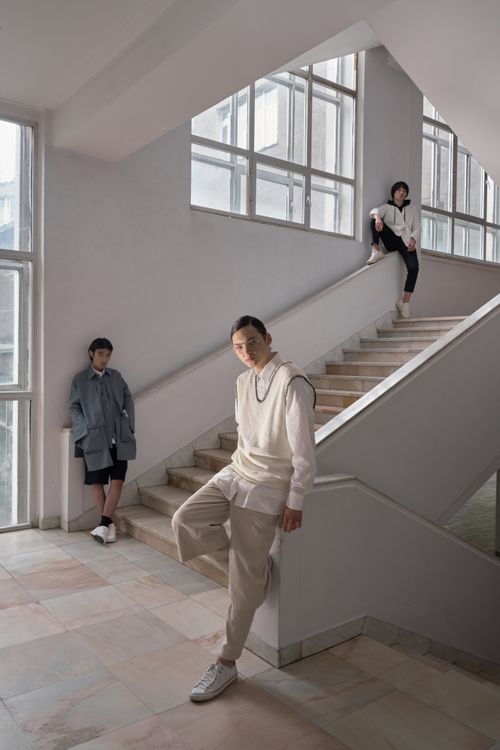Free Three stylish models posing on an elegant staircase indoors, showcasing modern fashion. Stock Photo