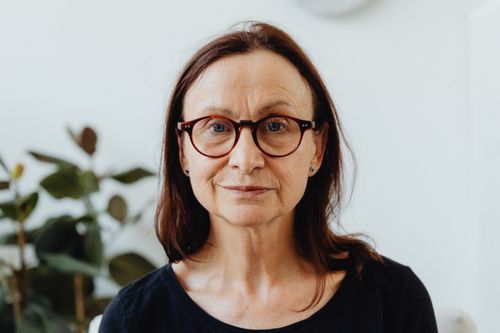 Free A close-up portrait of a mature woman indoors with eyeglasses, natural lighting. Stock Photo