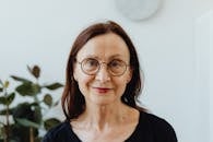 Woman in Black Scoop Neck Shirt Wearing Eyeglasses