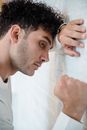 Man in White Shirt Holding His Face
