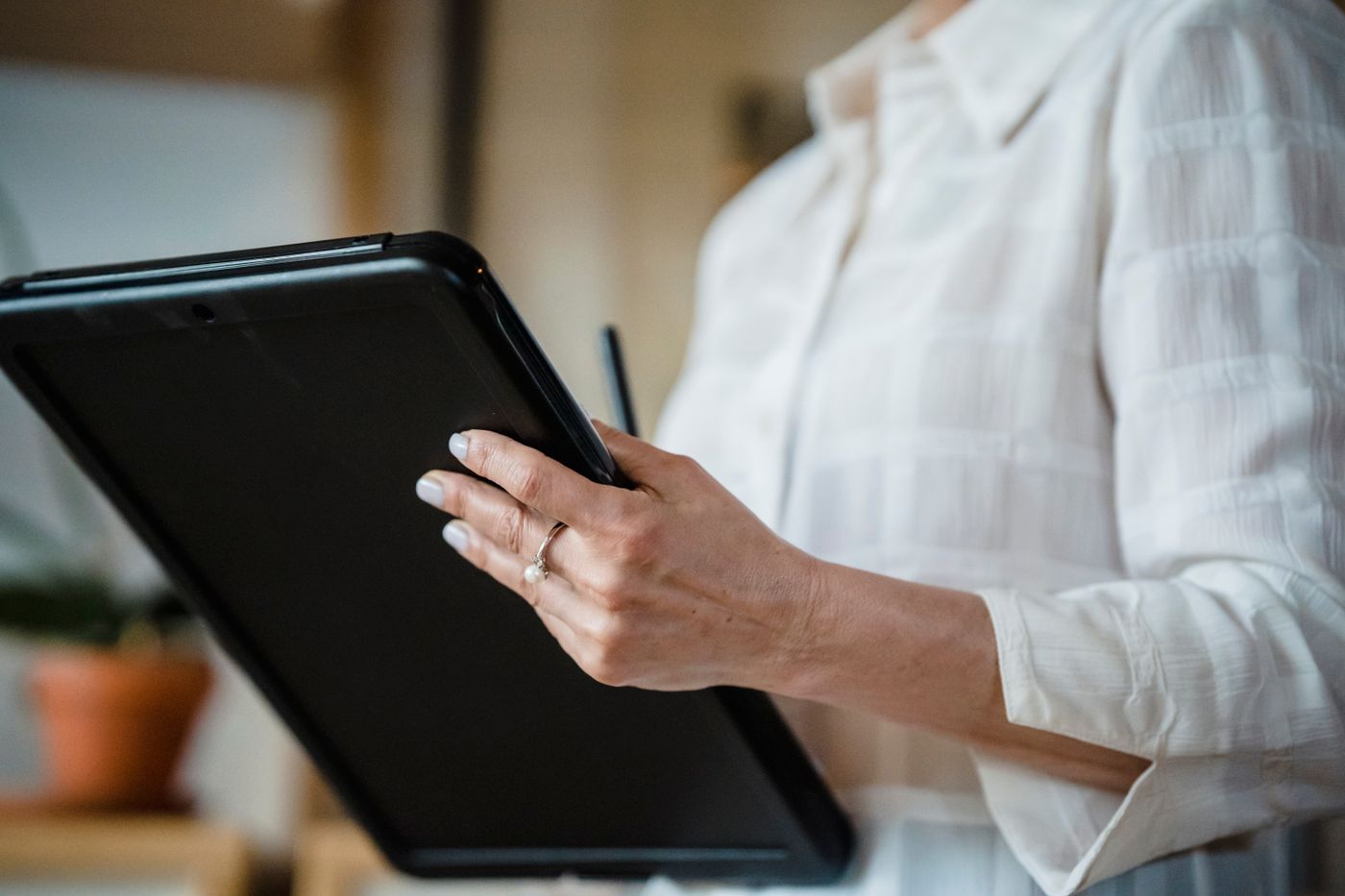 A designer holding a tablet and stylus in a bright studio — Timur Weber on Pexels