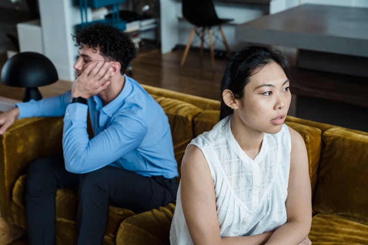 Angry Woman And Man On Couch