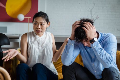 Free A couple having a serious conversation indoors, expressing emotions and misunderstanding. Stock Photo