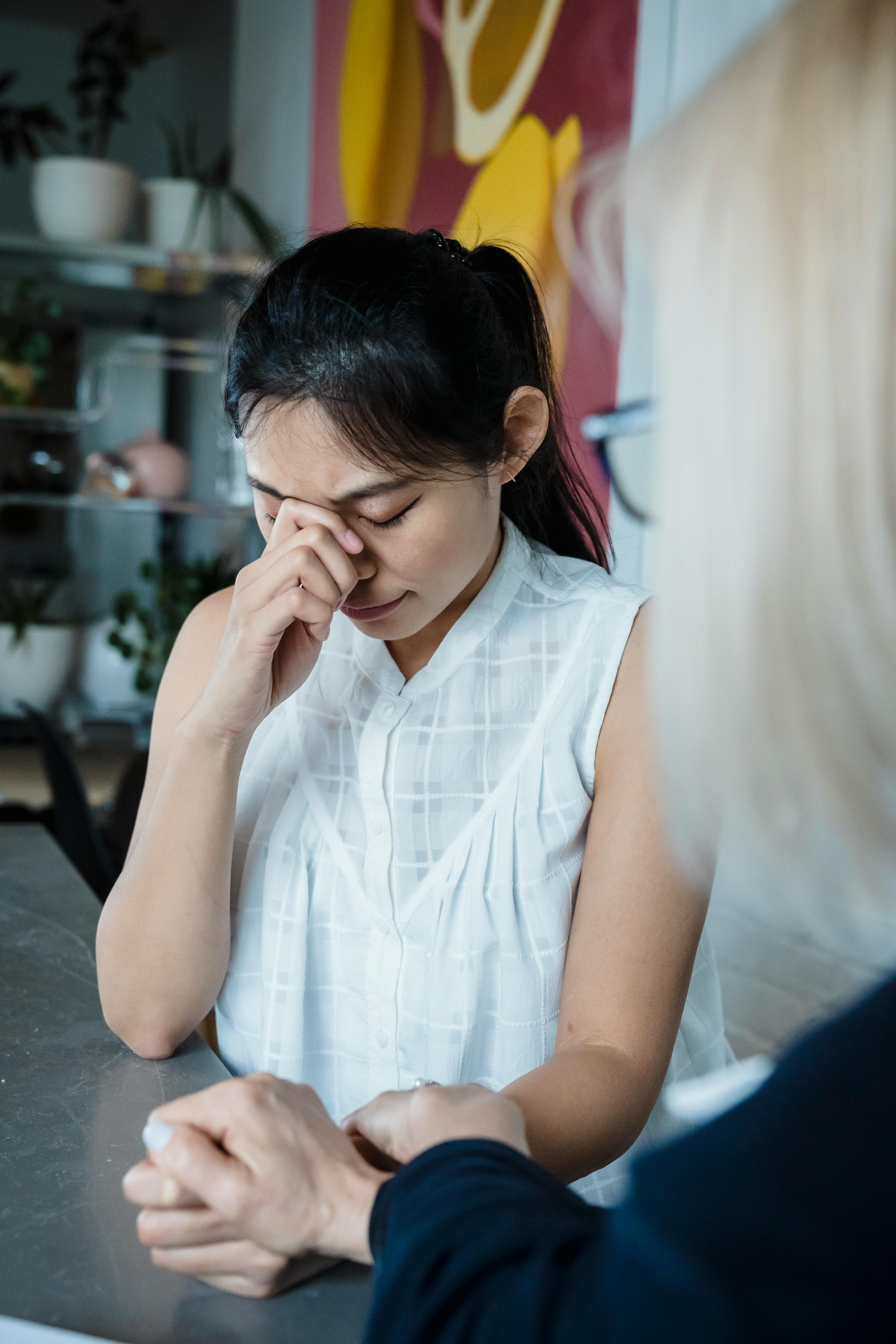 A woman receives comforting support while feeling emotional distress.
