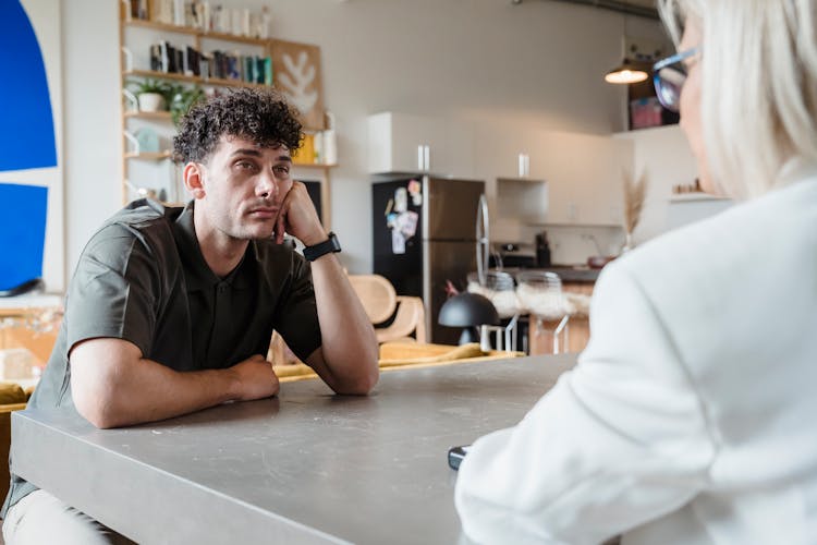 Man Looking Bored While Listening To The Person Talking 