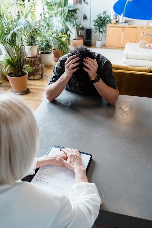 Emotional Patient Holding His Head