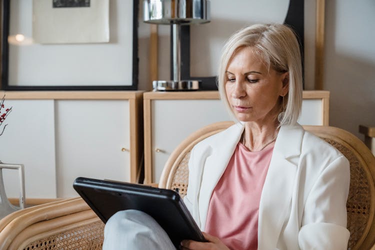 Elegant Mature Woman Sitting And Noting 