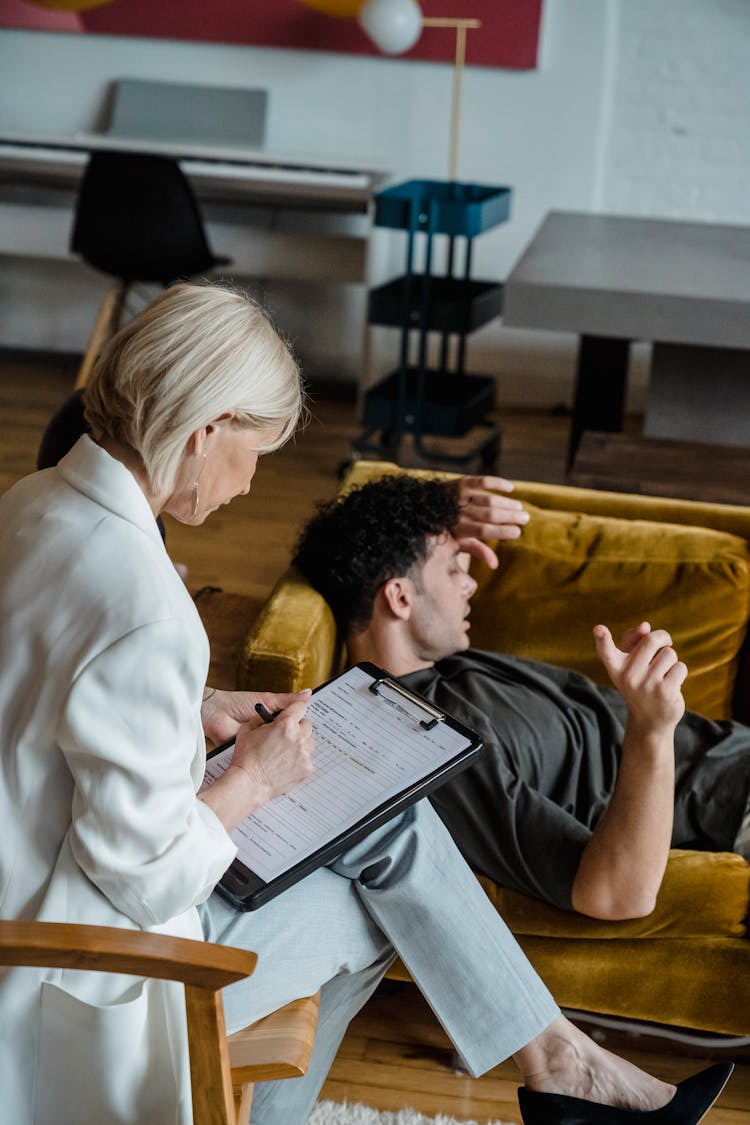 Young Man Lying On The Couch At A Therapy Session 